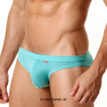 Turquoise textured fabric briefs with subtle pattern and small red brand tag on waistband from metromalewear