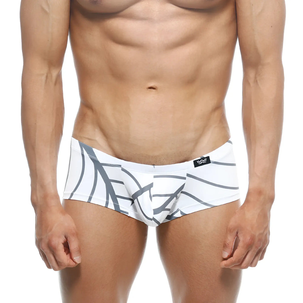 White swim trunks with bold gray abstract leaf pattern and black brand logo on waistband from metromalewear oscar boxer
