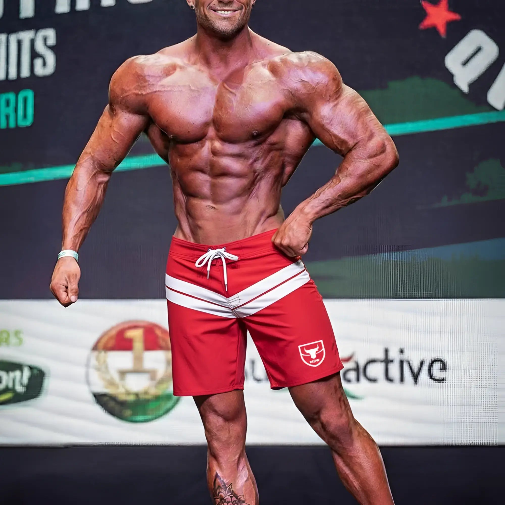 Red metro male wear physique board shorts with white stripes and a bull logo on the left leg for athletic use