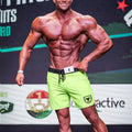 Bright neon green MetroMaleWear Physique board shorts with black waistband drawstring and shield logo on left leg