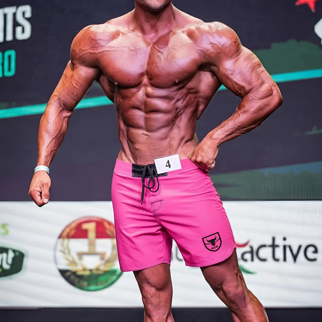 MetroMaleWear Physique board short pink with black drawstring waistband and shield logo on lower right leg