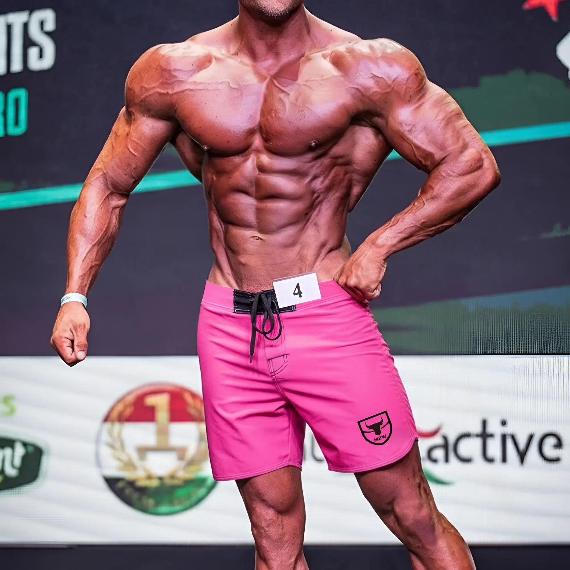 MetroMaleWear Physique board short pink with black drawstring waistband and shield logo on lower right leg