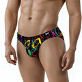 Black swim trunks by metromalewear with vibrant graffiti style neon pink yellow green and red lettering design