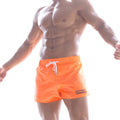 MetroMalewear pool party short orange swim trunks with white drawstrings and black logo on lower right leg