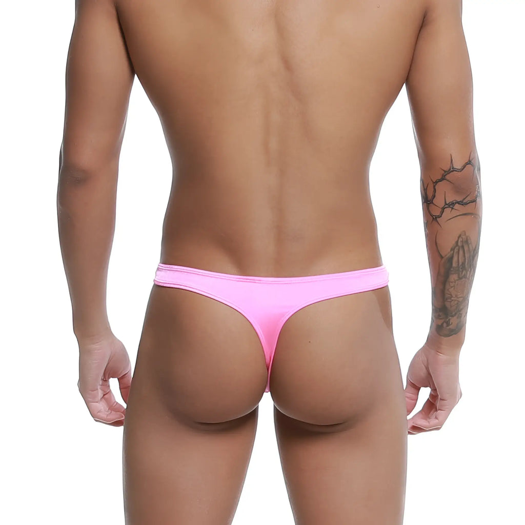 A vibrant pink form-fitting MetroMaleWear pouch thong made of smooth stretchy fabric shown from the back side