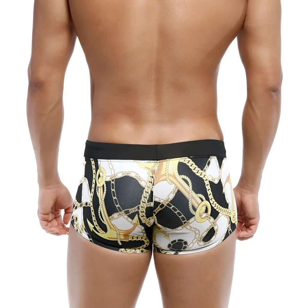 Black and white swim boxer briefs by metromalewear with bold gold anchor and chain pattern ideal for beachwear