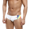 White swim trunks by metromalewear with vibrant rainbow stripe and small red brand tag for swimwear use