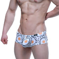 White briefs by metromalewear featuring a playful fried egg pattern in black outlines and orange yolks