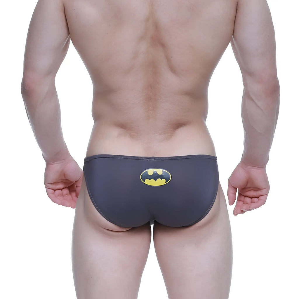 Dark gray batman-themed swim trunks with a yellow and black logo on the back by metromalewear
