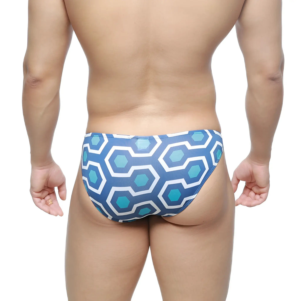 Blue and white geometric patterned swim trunks with a retro hexagonal design by MetroMaleWear super lowrise bikini
