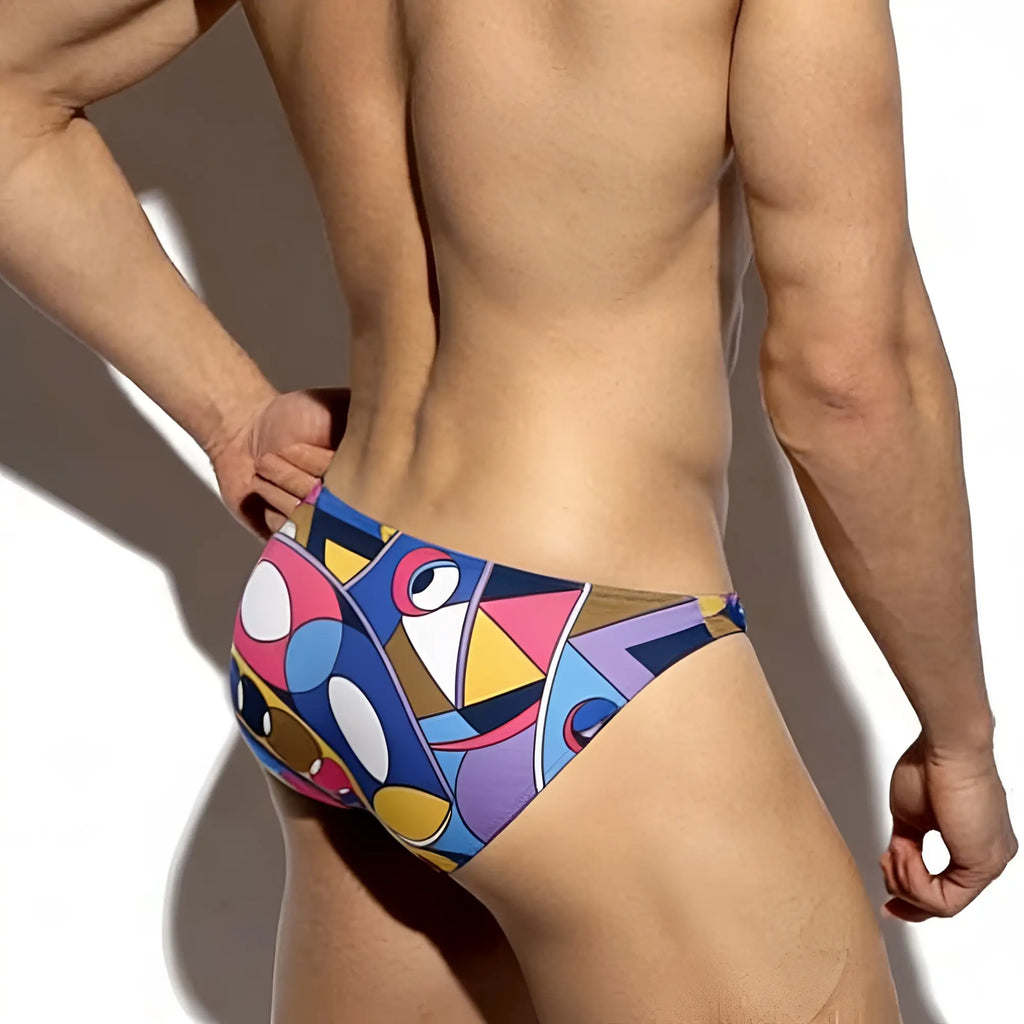 MetroMaleWear super lowrise bikini swim trunks with vibrant geometric patterns in bold blues pinks yellows and purples