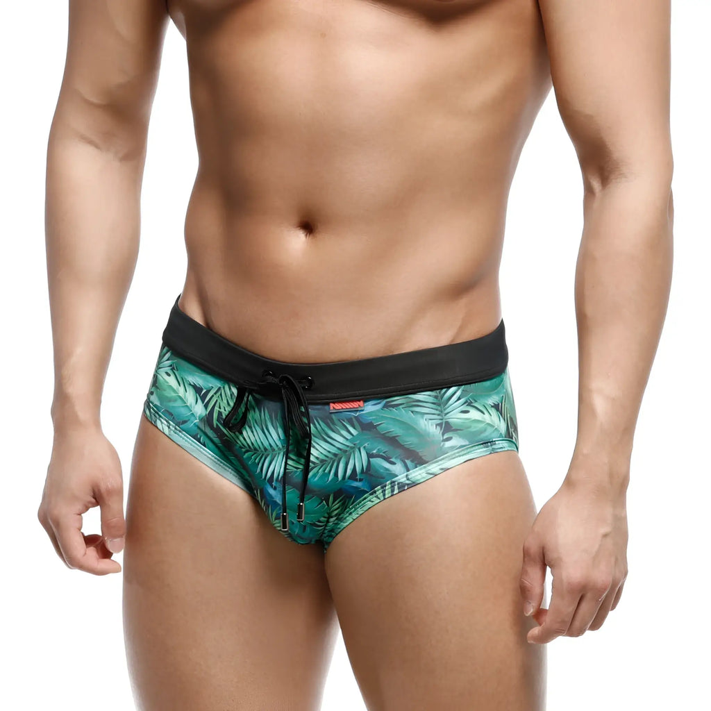 Green tropical leaf-patterned swim trunks with black elastic waistband and drawstring from MetroMaleWear metrobrief line