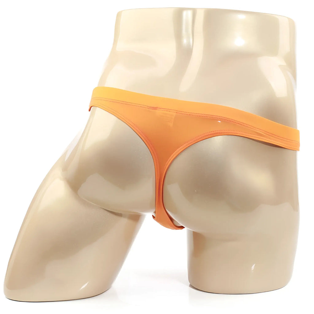 Metro malewear tasman orange thong displayed on a mannequin highlighting its sleek design and vibrant color