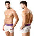 White terry sport shorts by metromalewear with purple waistband trim and orange logo on side