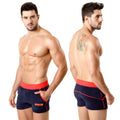 Navy blue terry sport shorts with red elastic waistband and trim featuring small orange logo on lower left leg by metromalewear