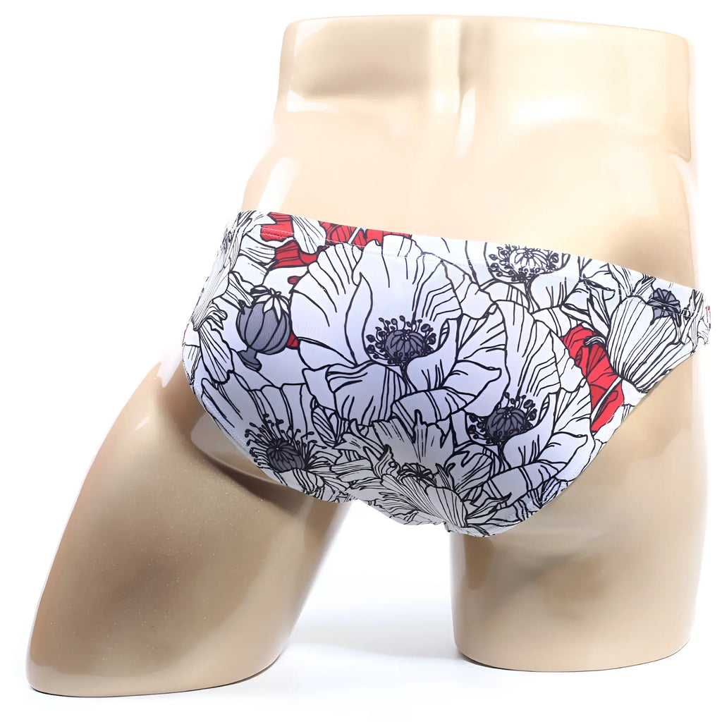 White swim trunks metroMalewear vendeta bikini blossom 2614-09 with bold floral pattern black outlines red accents