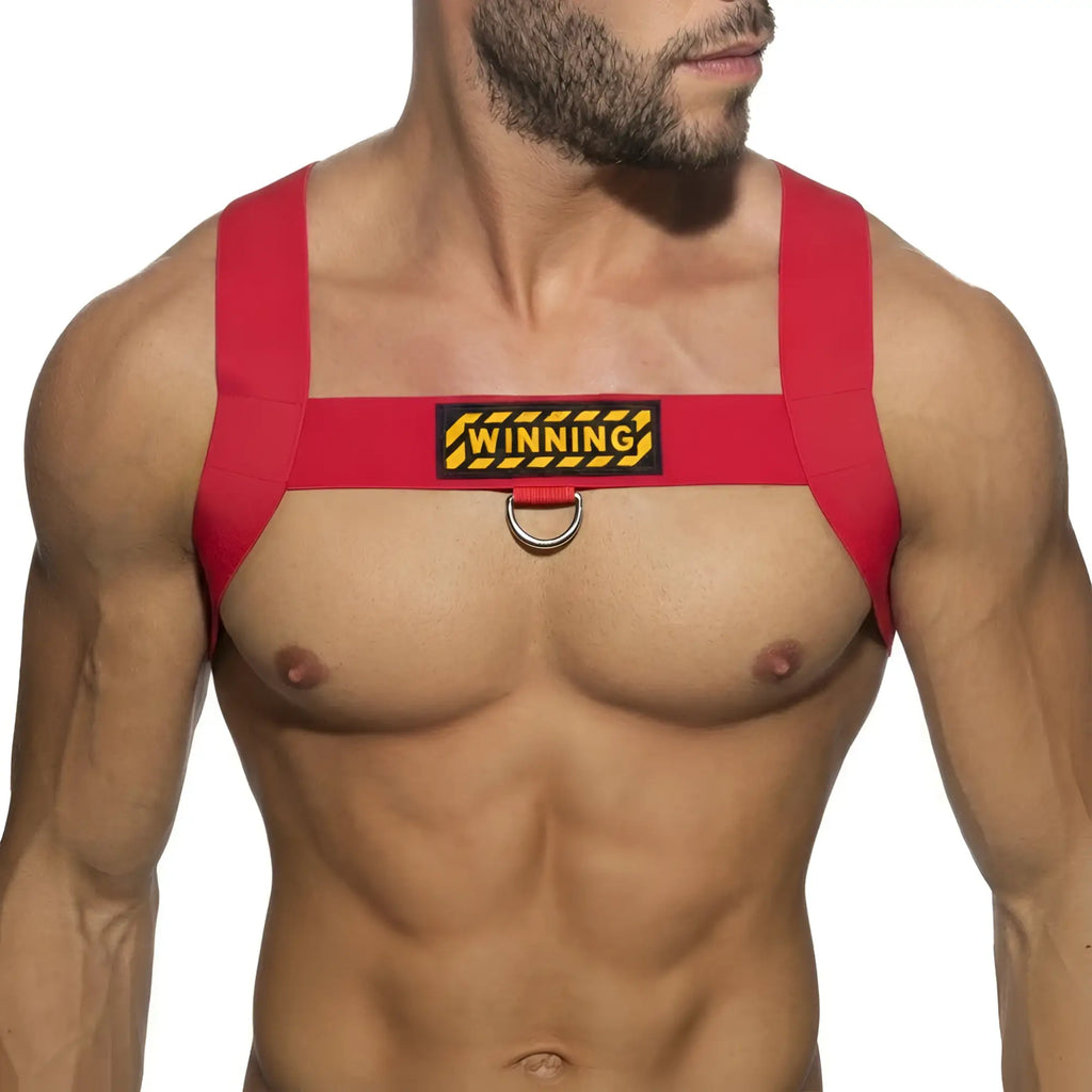 Red fabric MetroMaleWear WINNING harness with yellow and black patch and metal ring for stylish wear and support