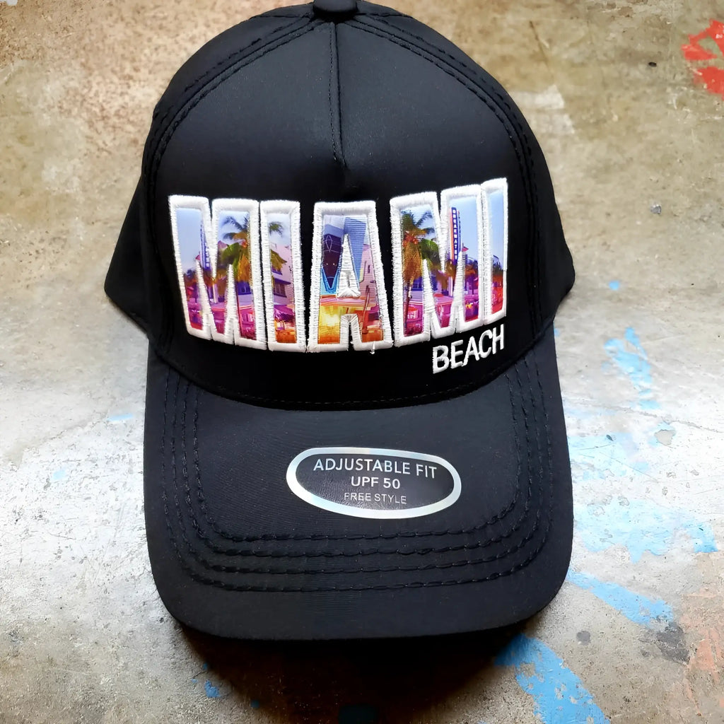 Black trucker hat with colorful embroidered miami design featuring palm trees and cityscape in vibrant hues