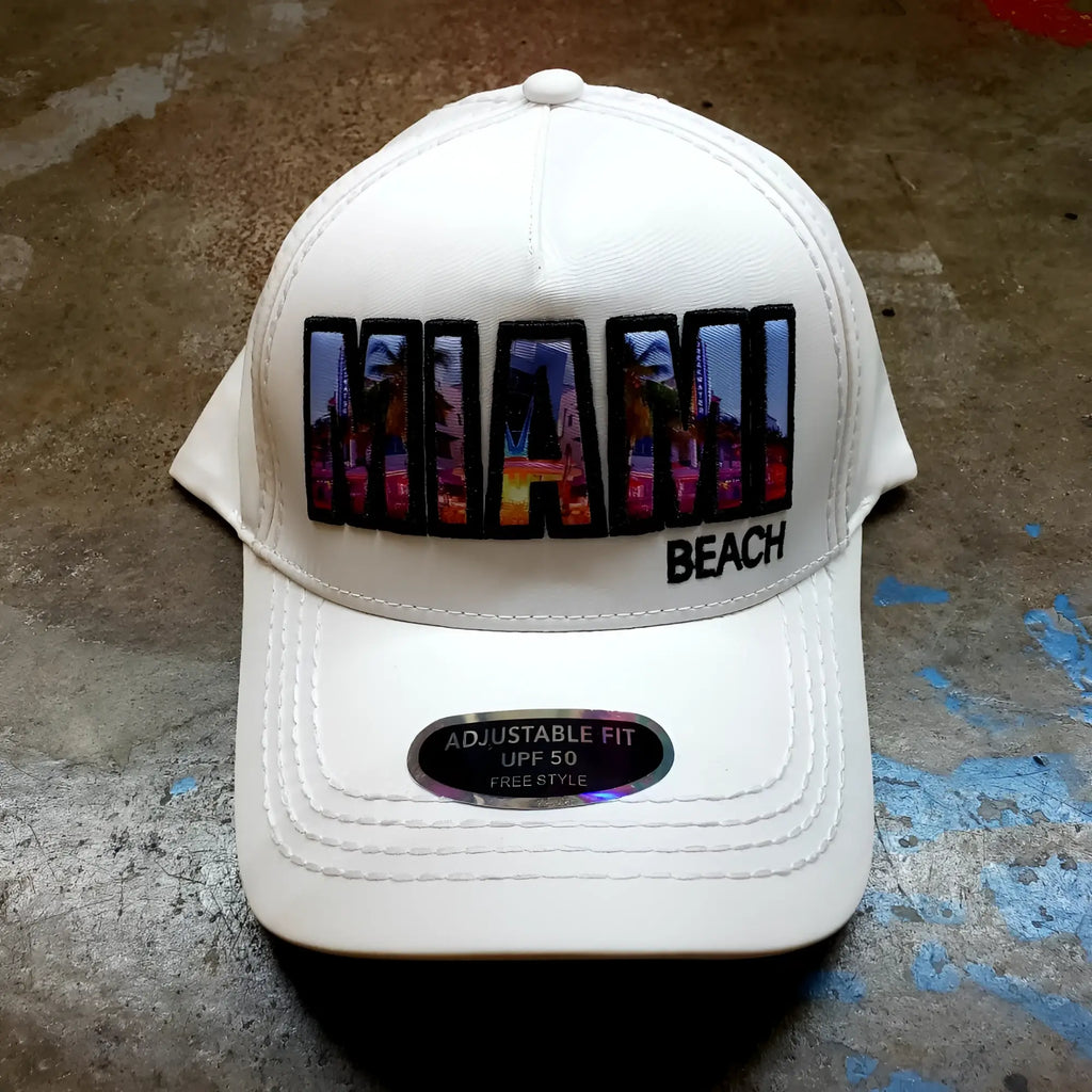 White baseball cap with vibrant colorful miami beach patch and black trim featuring urban skyline design