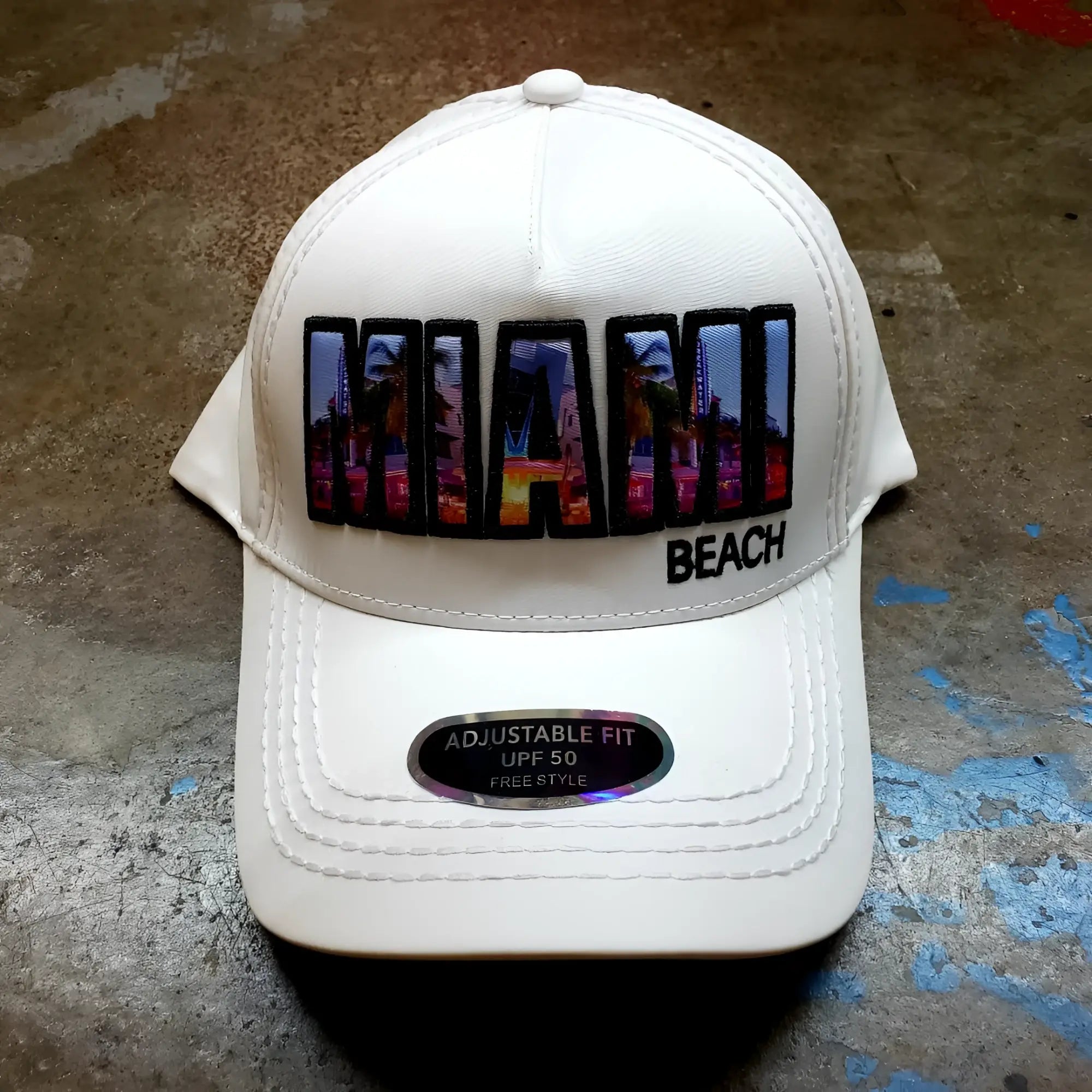 White baseball cap with vibrant colorful miami beach patch and black trim featuring urban skyline design