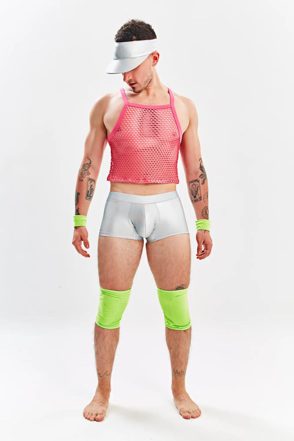 A man wearing a bright pink mesh tank top silver briefs and neon green knee-high socks in Miami Jock Barbie Halloween costume
