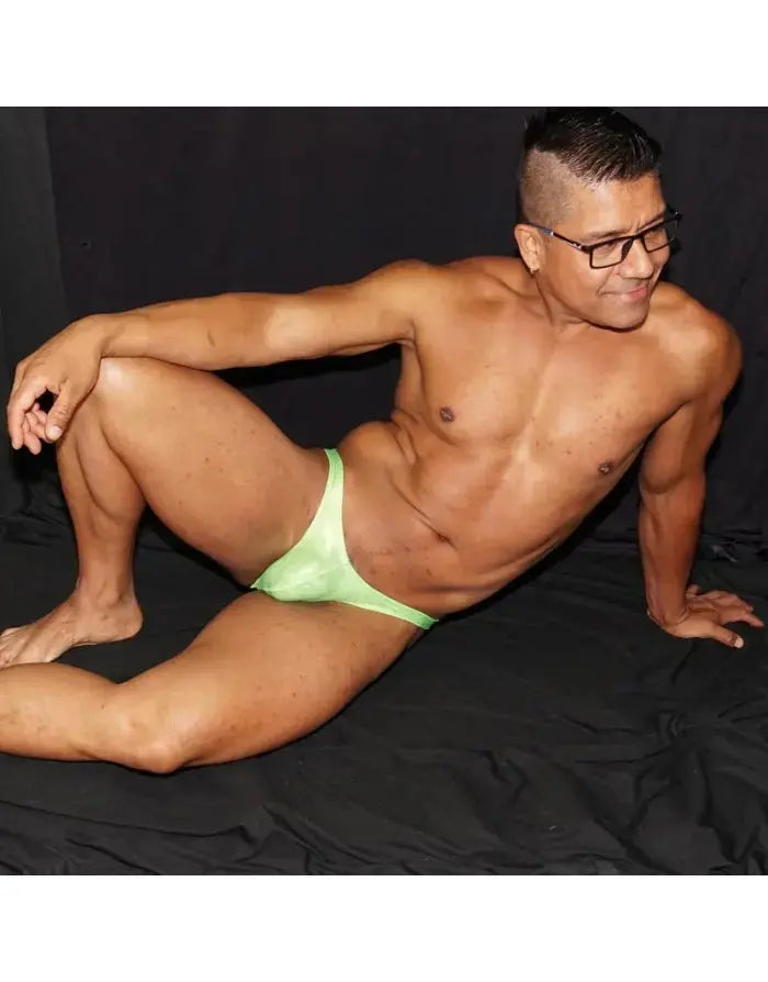 Fluor green micro bikini underwear by Arroyman featuring a sleek design soft material and minimal coverage modeled by a man.