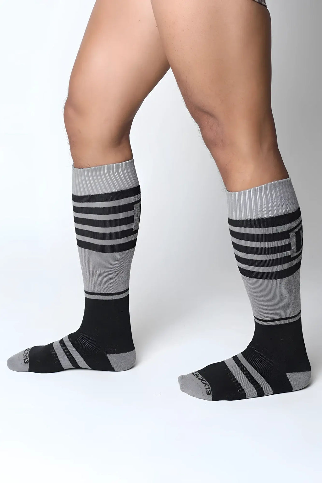 Midfield knee high sock in black and gray stripes with ribbed cuff made for comfortable all day wear