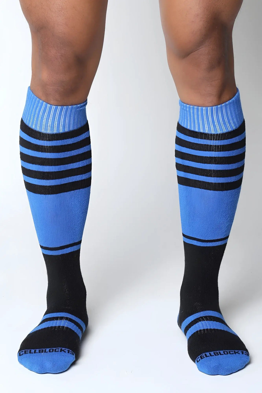 Midfield knee high socks in blue and black stripes with ribbed cuffs and cellblock branding on the toe