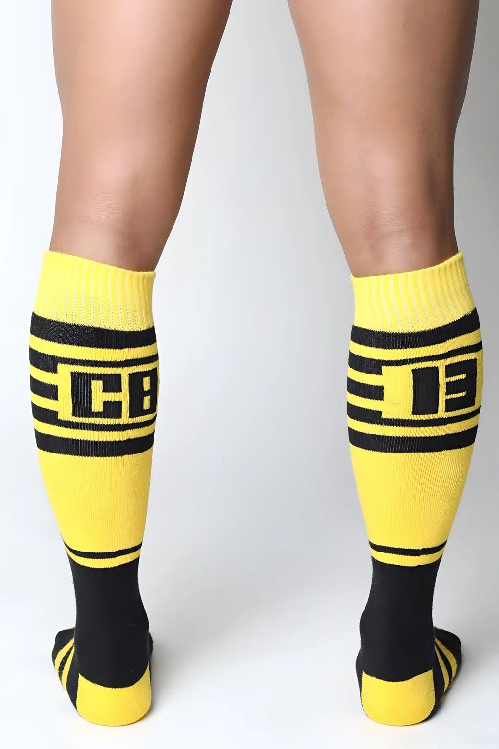 Midfield knee high socks in bright yellow and black with bold horizontal stripes and a prominent cb logo center