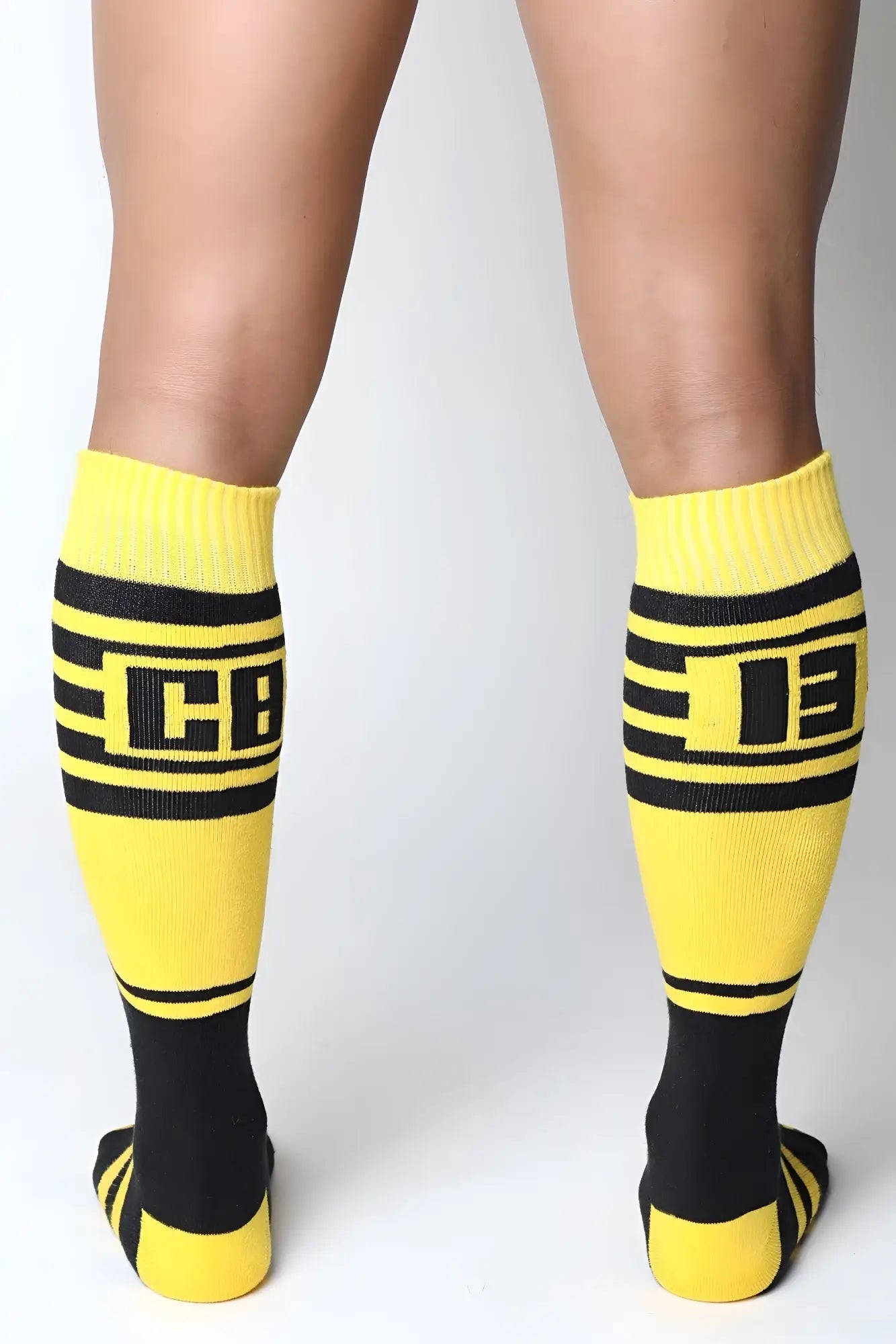 Midfield knee high socks in bright yellow and black with bold horizontal stripes and a prominent cb logo center
