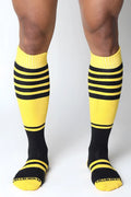 Bright yellow and black striped midfield knee high socks with ribbed texture and cellblock13 logo on the toe