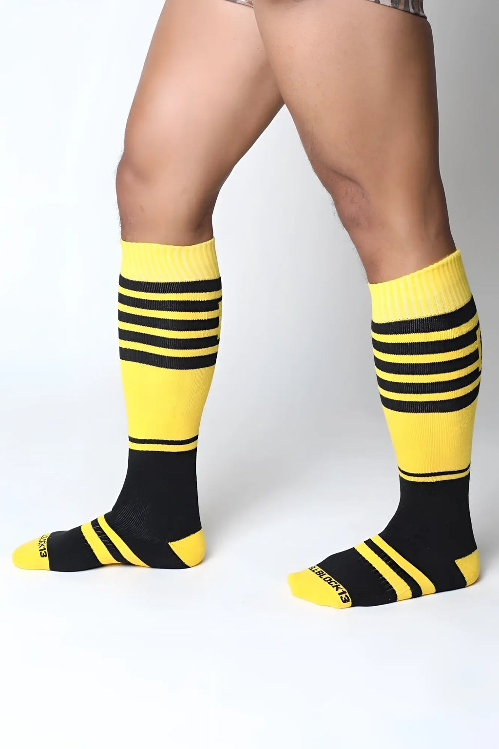 Bright yellow and black striped midfield knee high socks with ribbed cuff and extraboots brand on heel back side