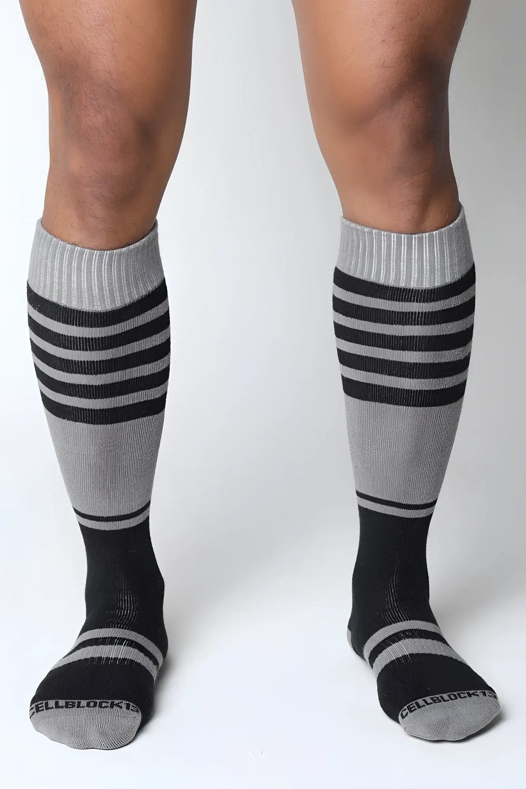 Midfield knee high socks in gray and black stripes with ribbed cuff and cellblock brand name on the toe