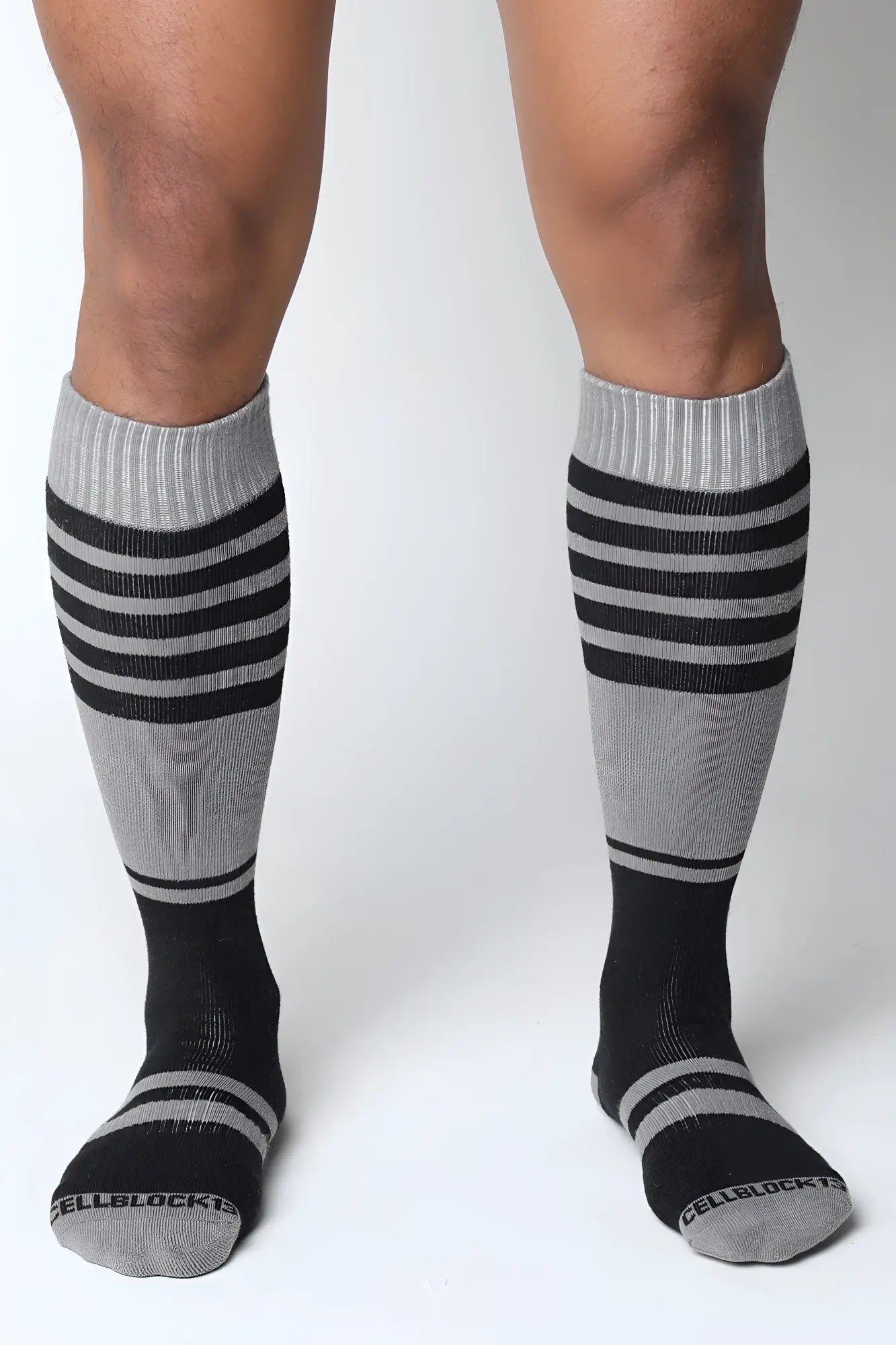 Midfield knee high socks in gray and black stripes with ribbed cuff and cellblock brand name on the toe