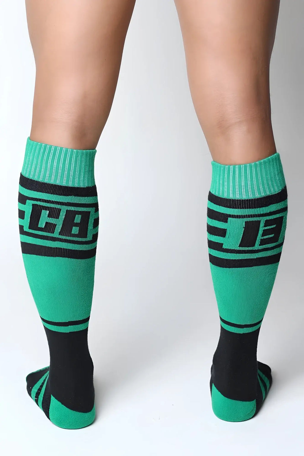 Green and black athletic midfield knee high socks with bold lettering on the calf for sports and training use