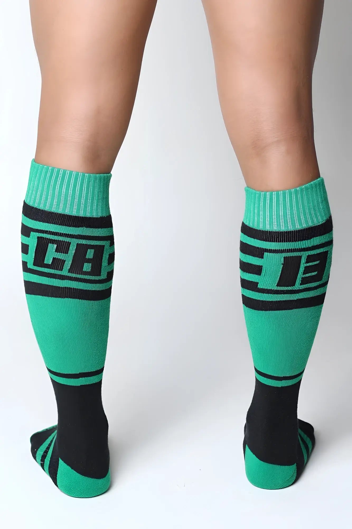 Green and black athletic midfield knee high socks with bold lettering on the calf for sports and training use