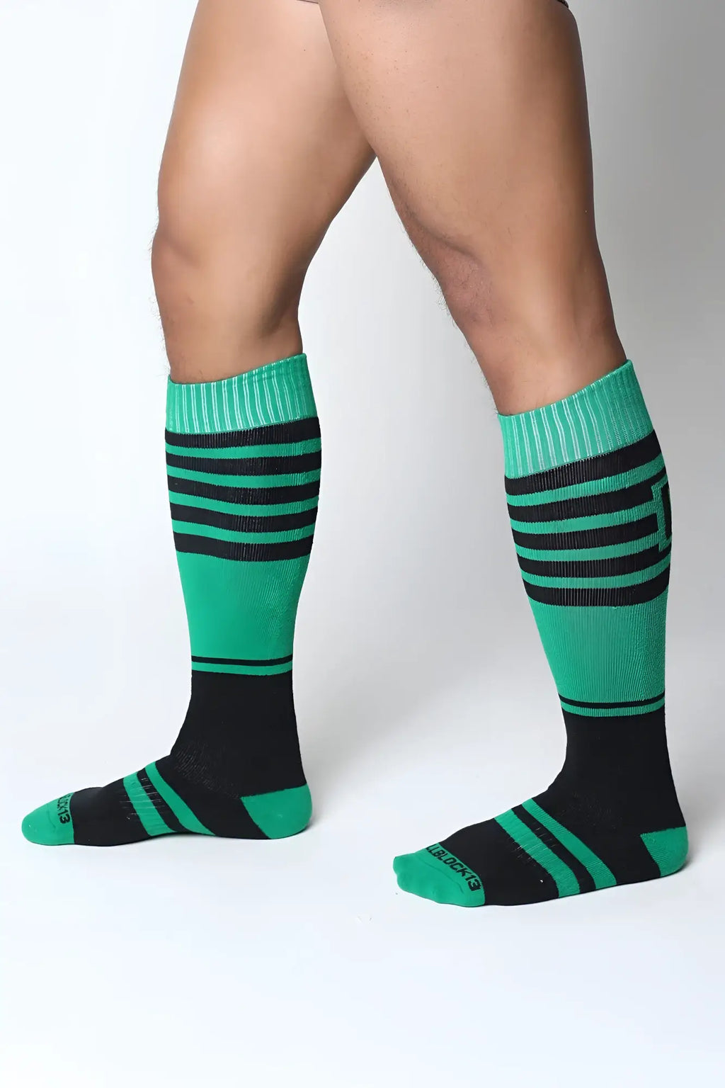 Midfield knee high sock with green and black stripes and ribbed cuffs made for comfortable wear