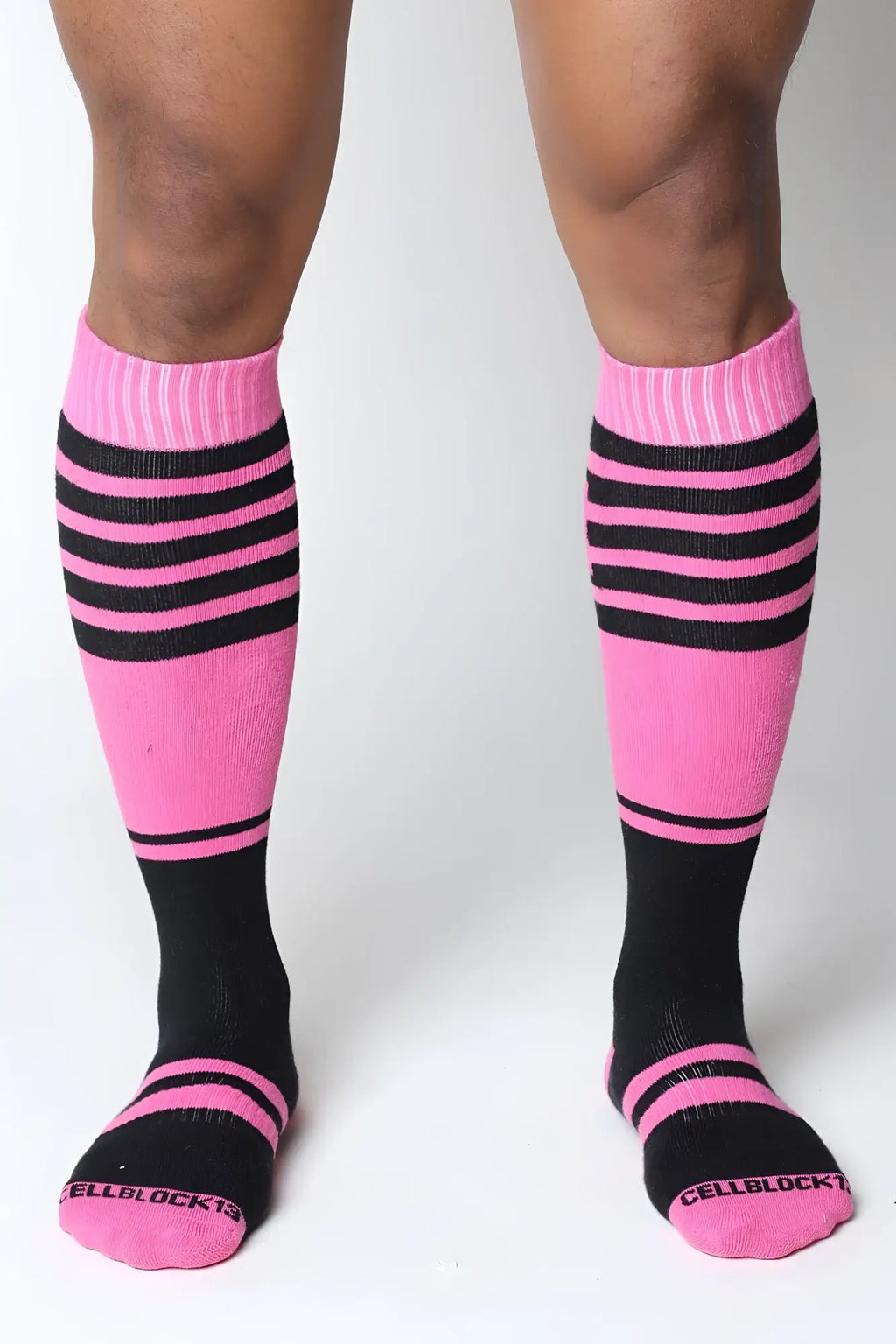 Midfield knee high socks in pink and black stripes with ribbed cuff and cellblock13 logo embroidered on the toe