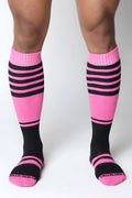 Midfield knee high socks in pink and black stripes with ribbed cuff and cellblock13 logo embroidered on the toe