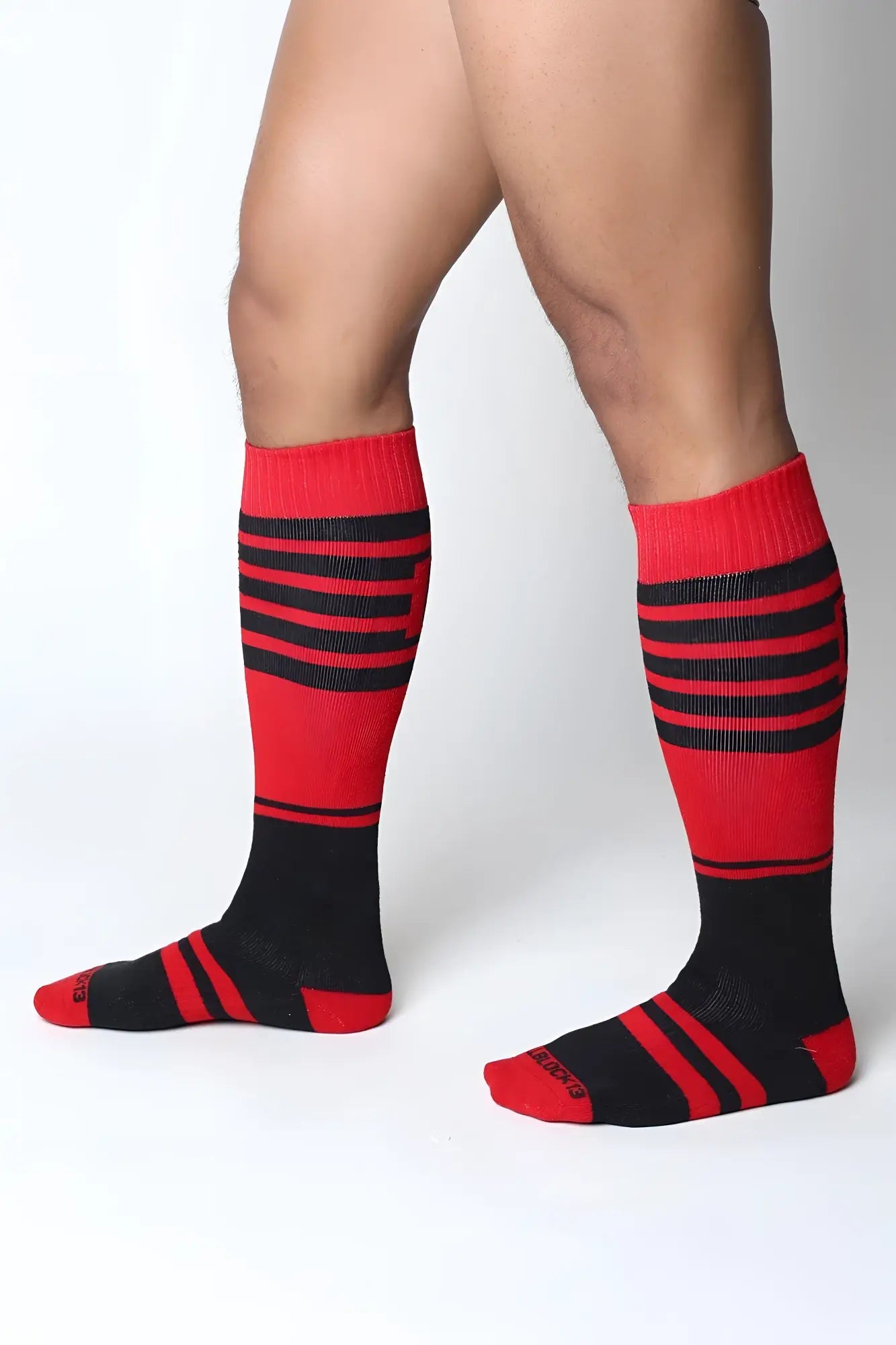 Red and black striped midfield knee high socks with ribbed texture made for comfortable all day wear