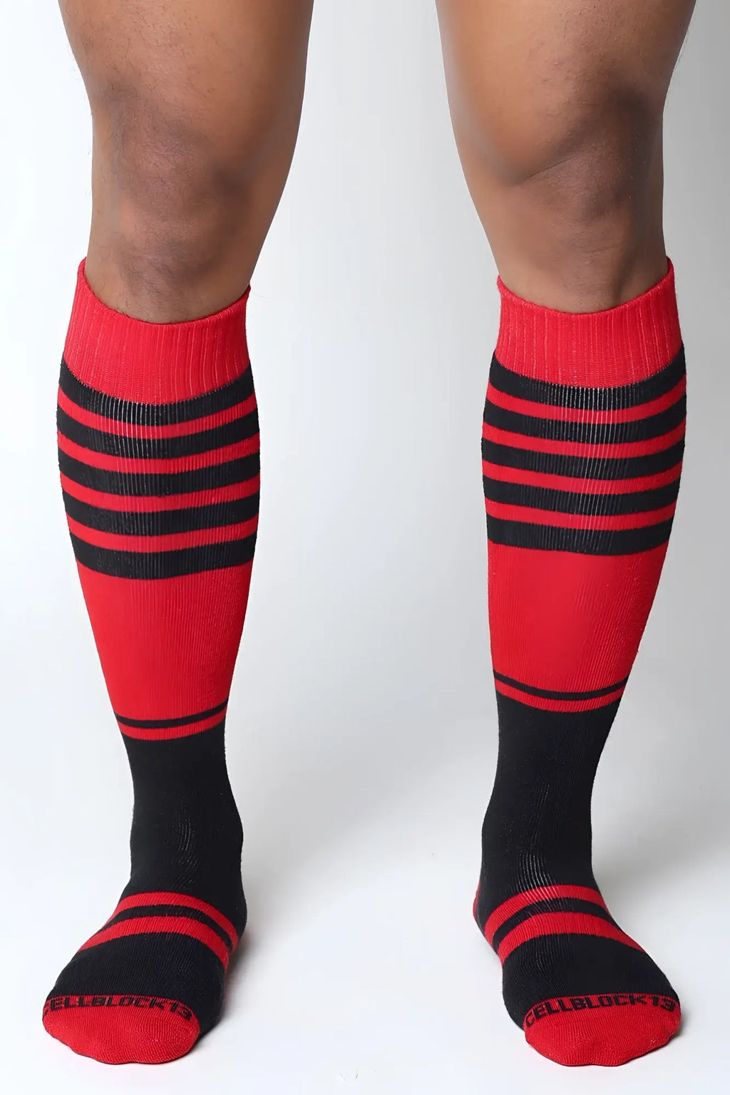 Midfield knee high socks in red and black stripes with ribbed texture and cellblock 13 branding on the toe