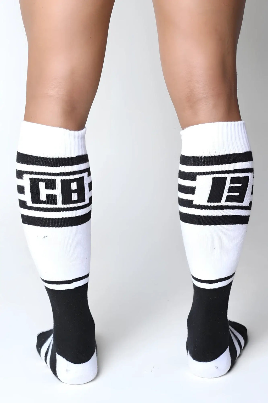Midfield knee high socks in white and black with bold stripes and cb logo on the calf for athletic use