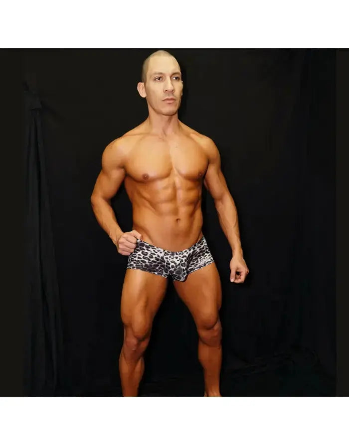Men's black leopard print mini boxer underwear by Arroyman featuring a snug fit and soft fabric modeled by a man.
