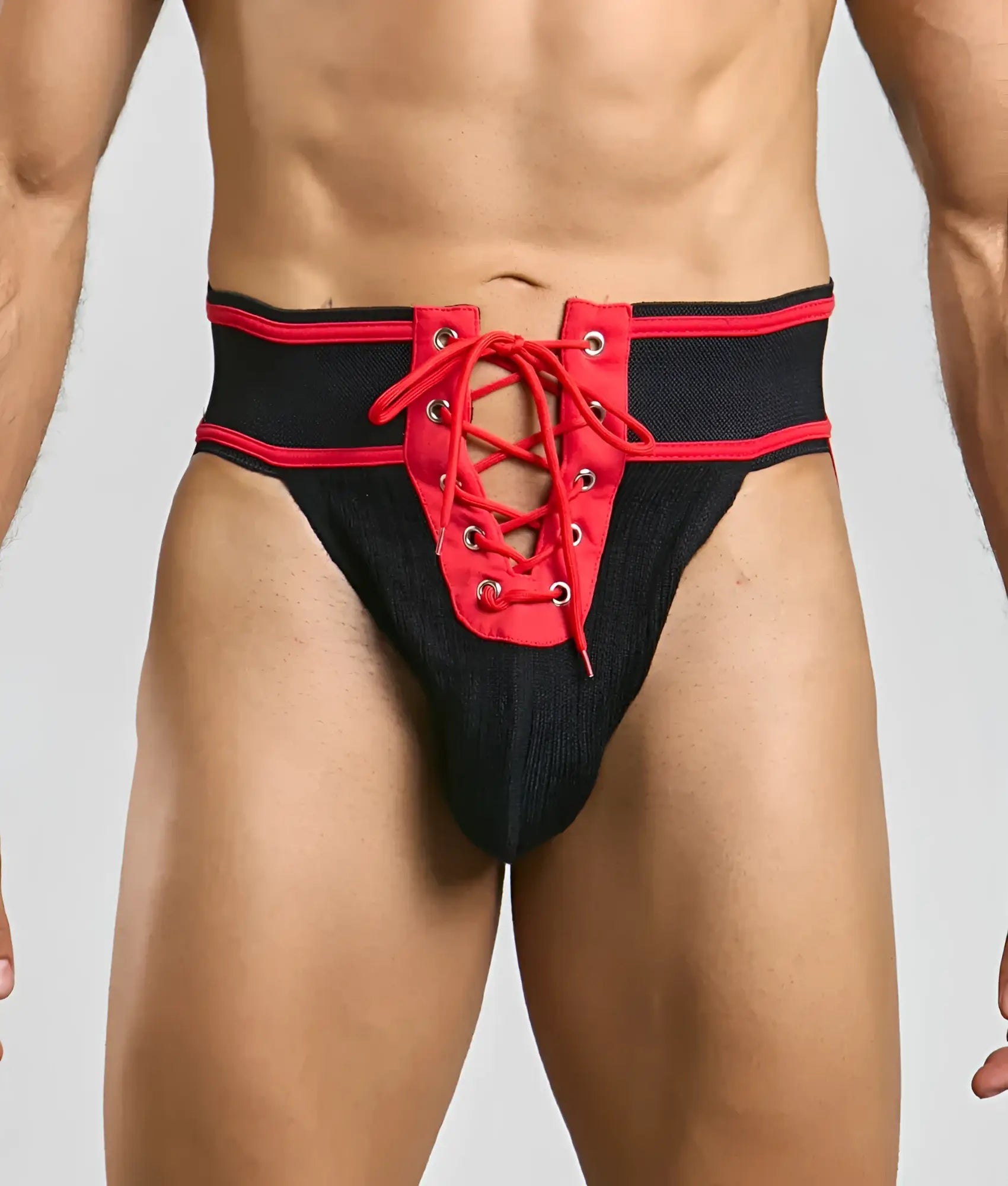 Mob football jockstrap in black and red with lace-up design and textured fabric waistband front view