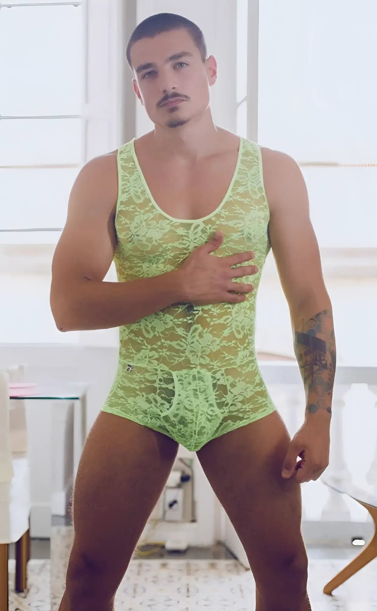 MOB men’s lime green lace bodysuit with intricate floral patterns made from delicate lace material