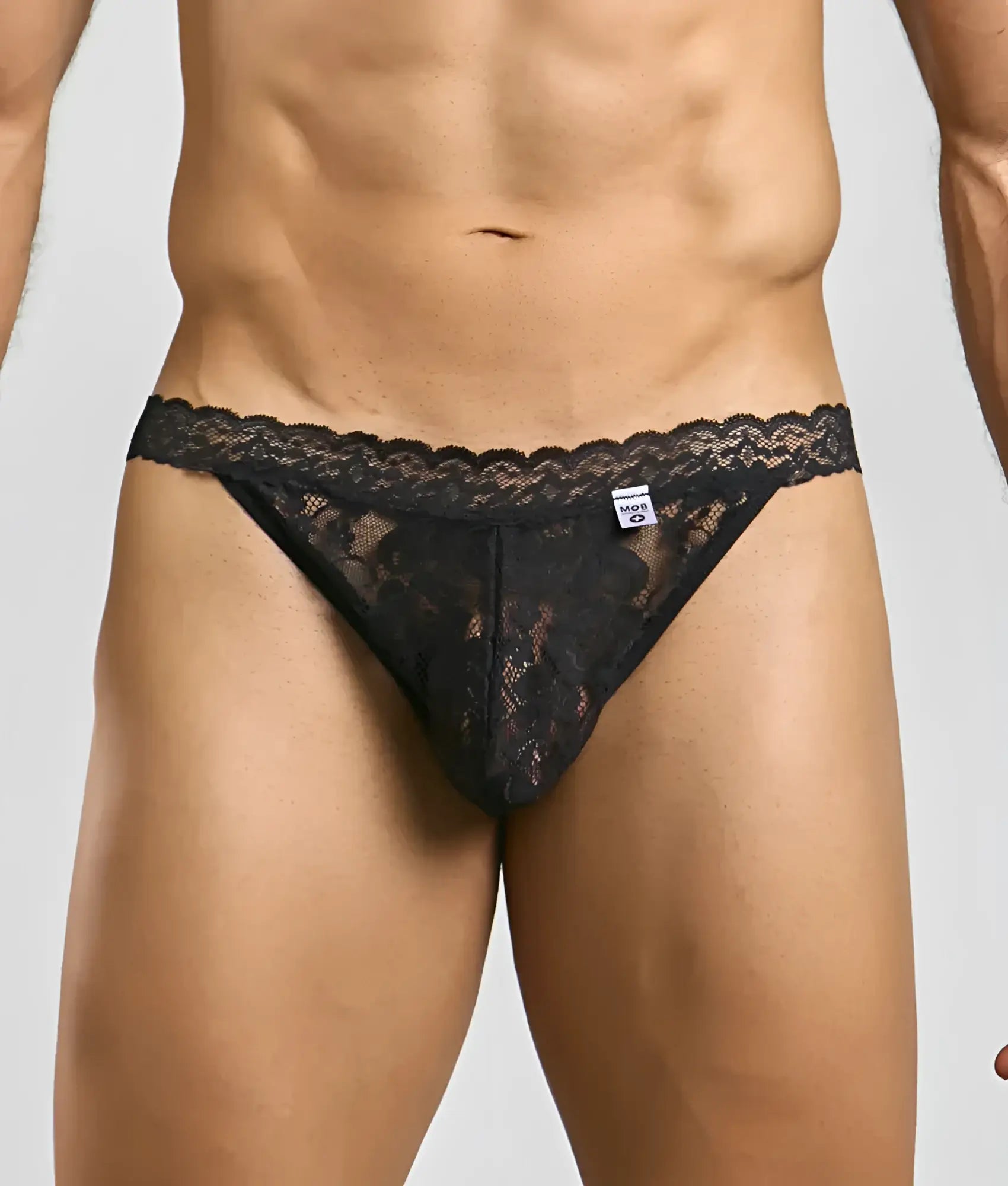 Black lace thong men’s jockstrap with intricate floral patterns and scalloped edge from mob