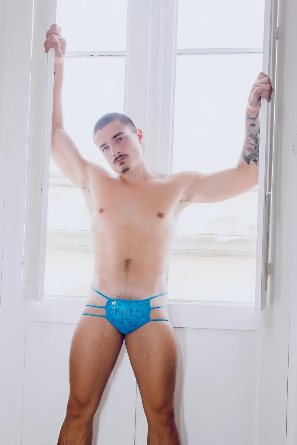 Mob men’s lace pouch thong in blue lace trimmed briefs with subtle pattern and thin side straps