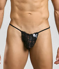 Black lace thong with thin elastic straps and small white MOB brand tag for men