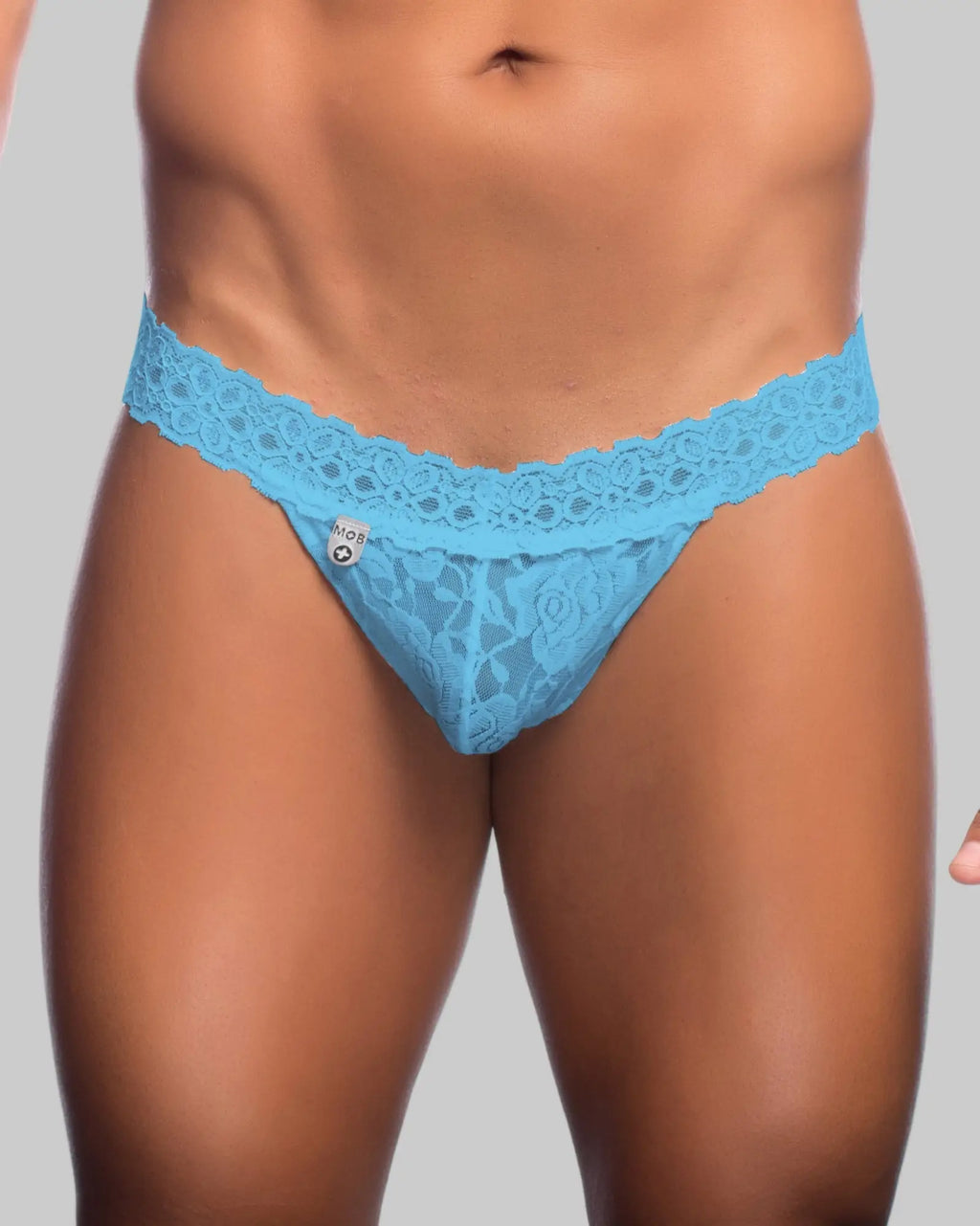 Light blue lace thong with floral pattern and branded tag from MOB mens lace waist thong collection