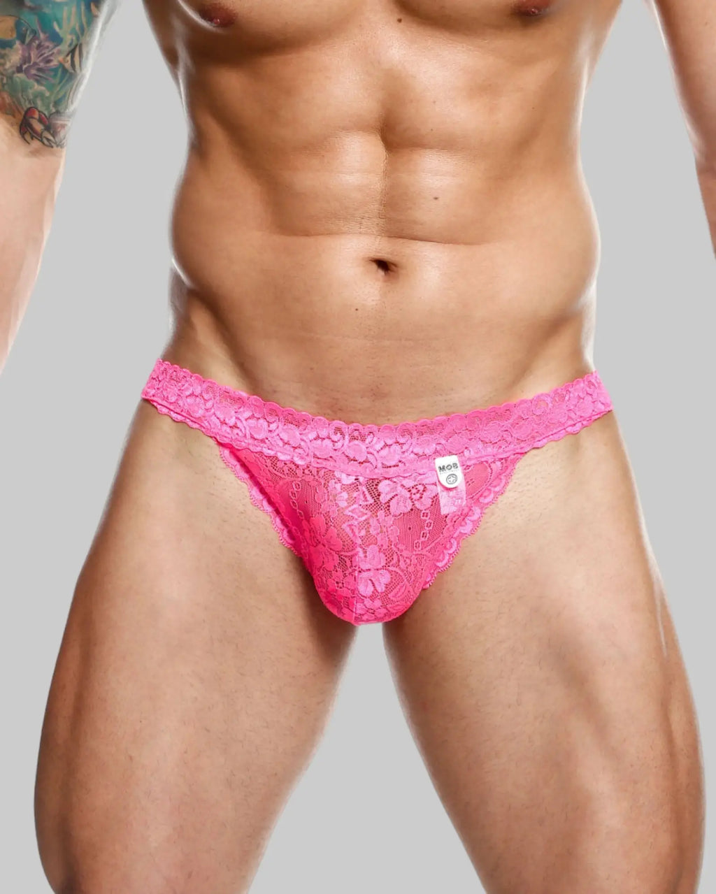 MOB men’s lace waist thong in vibrant pink with intricate floral patterns and delicate sheer lace design